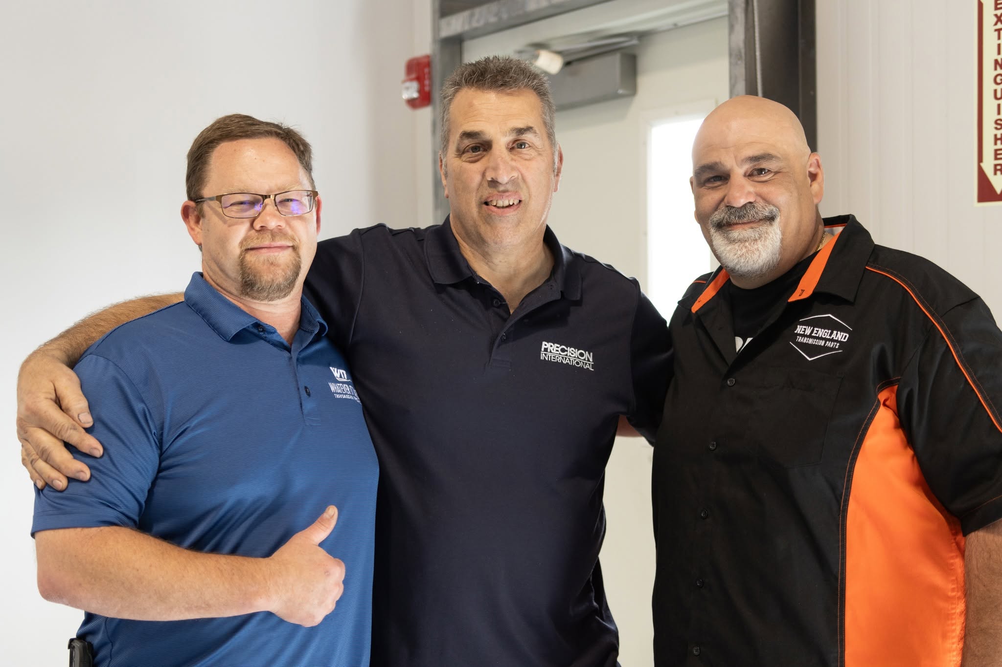 Three transmission industry colleagues together, wearing WIT, Precision International and NETP shirts
