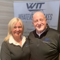Two members of the transmission community at a WIT event display